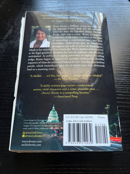 WHILE JUSTICE SLEEPS: A Thriller by Stacey Abrams